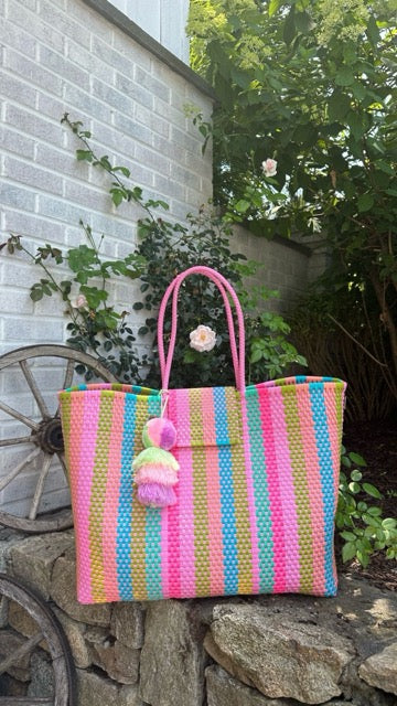 Front view of the Rain Paradise Citron Tote showcasing its vibrant handwoven design and classic pompom accent.