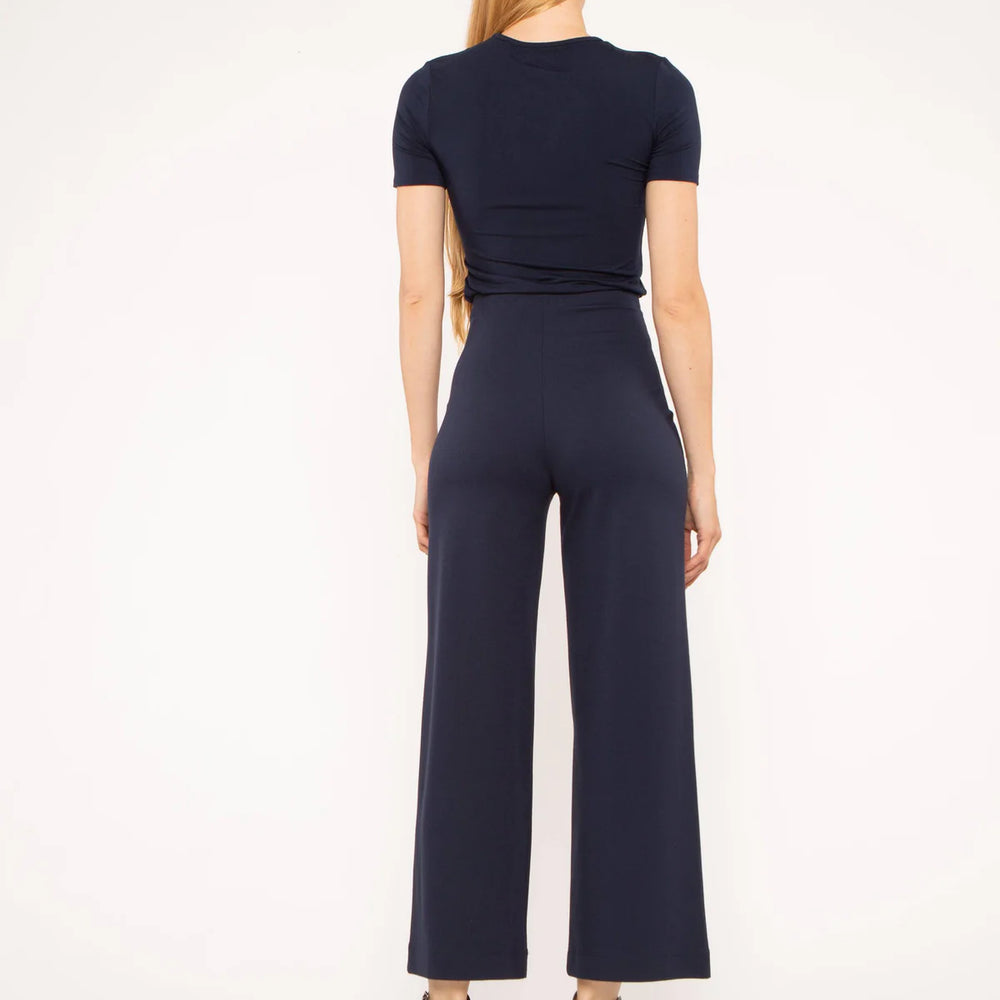 Back view of versatile navy cropped pants, perfect for travel and daily wear.