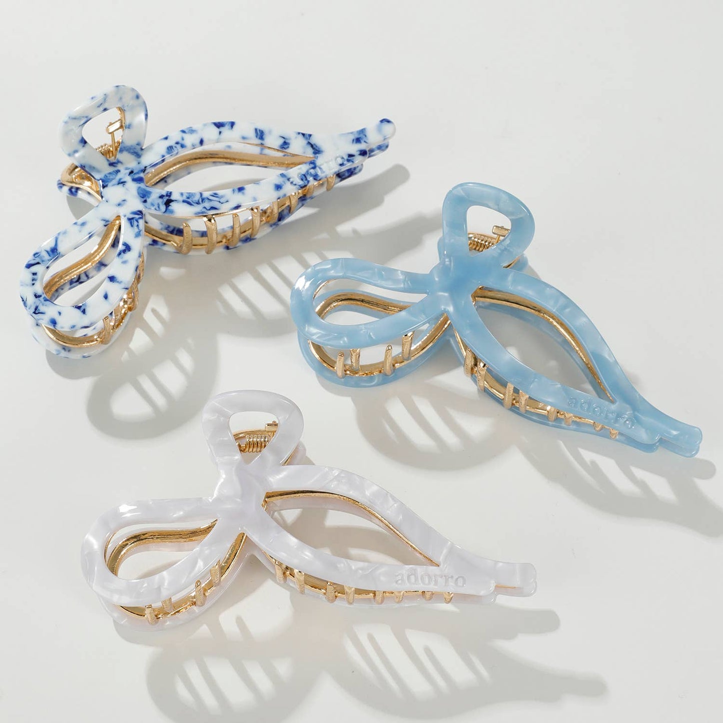 Large Sabrina Coastal ribbon bow claw clip in 3 colors - Coastal Blue & White, Saltwater Blue, and Pearl - blue tones with gold metal base.