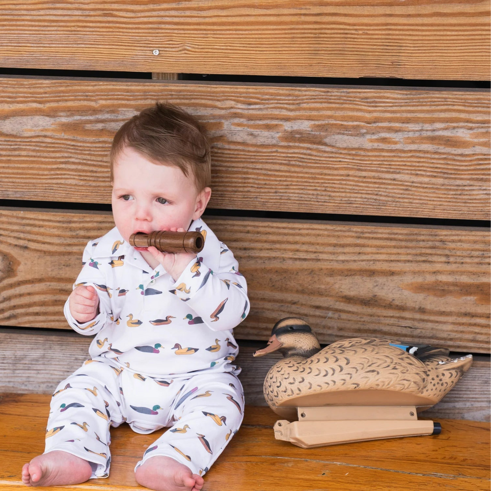 
                      
                        Baby wearing SBC Signature Polo Long-Sleeve Romper, sitting and holding a duck call, highlighting soft, breathable fabric and playful style.
                      
                    
