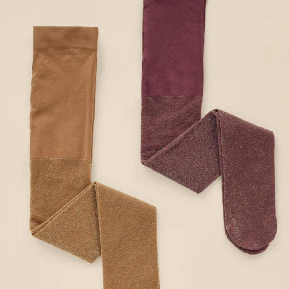 Flat lay of Noralee Shimmer Tights in rich Golden and Fig, showcasing subtle sparkle and elegant fall colors.