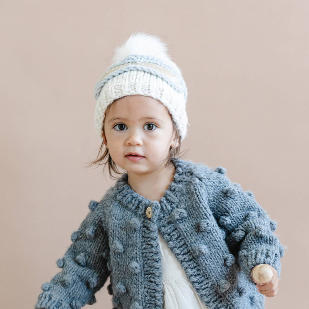 
                      
                        Child wearing cream Ski Goggles Beanie while playing in winter outdoors
                      
                    