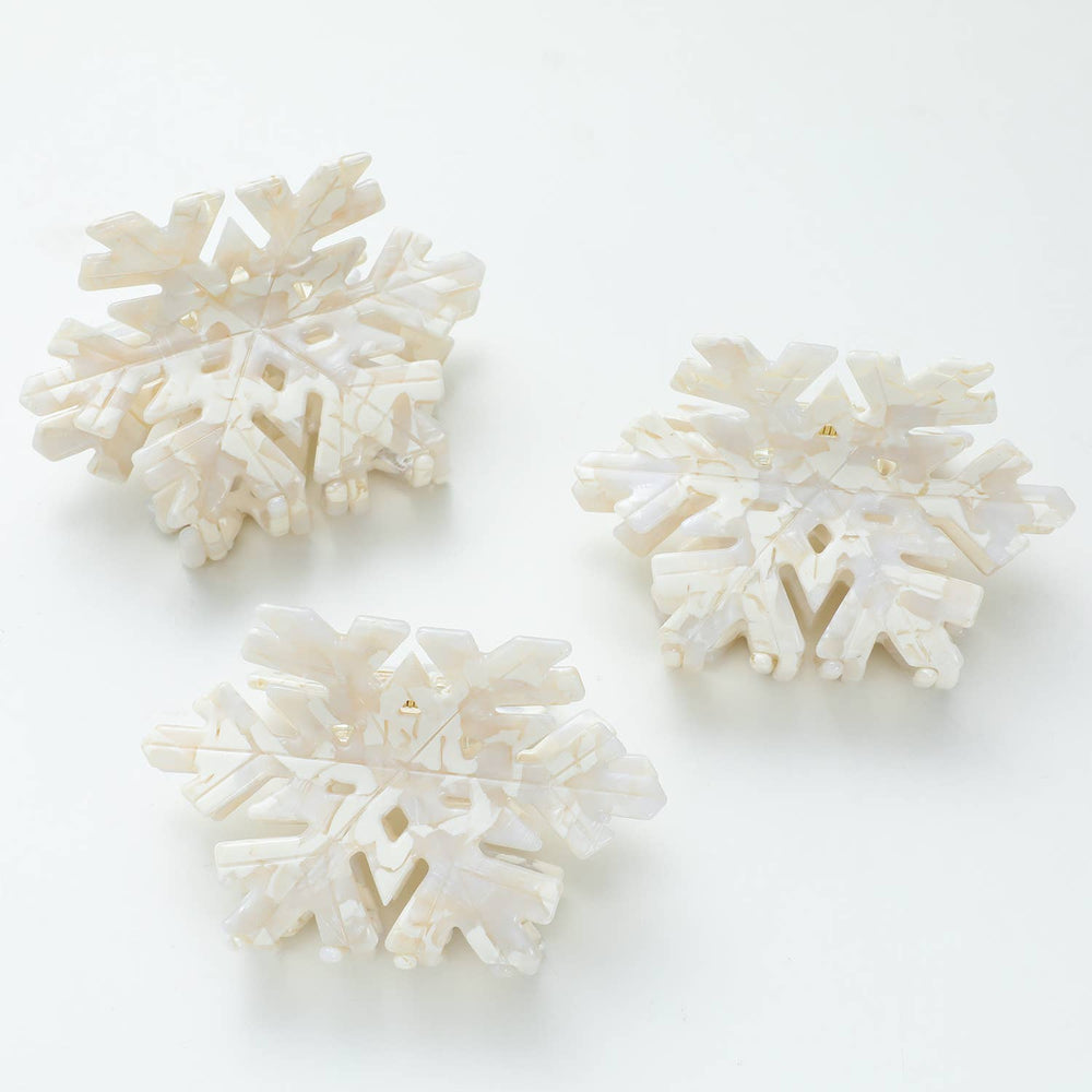 
                      
                        Three Snowflake Medium claw clips flatlay highlighting festive design, biodegradable cellulose acetate, and flexible teeth for medium to long hair
                      
                    