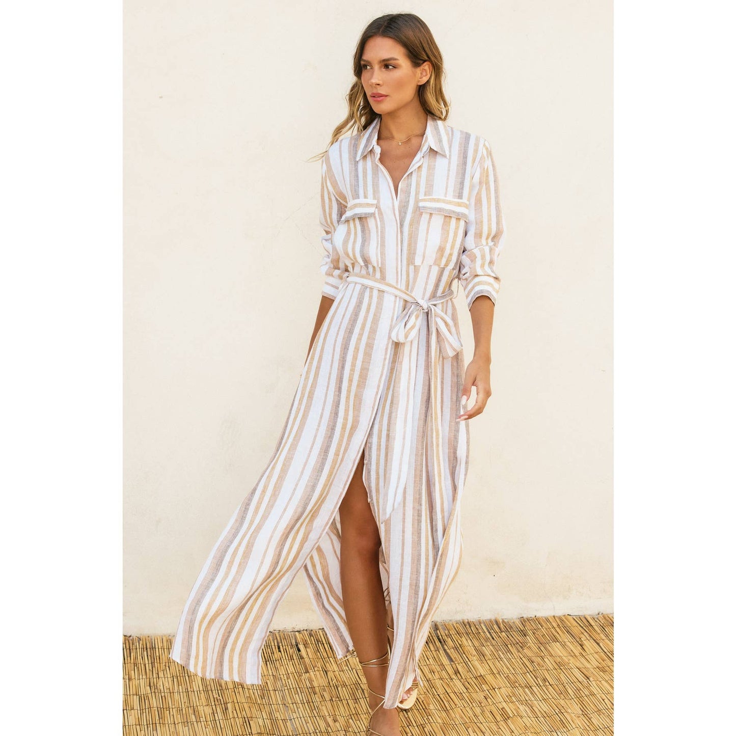 Model walking in the striped maxi shirt dress, side slit and fabric movement visible