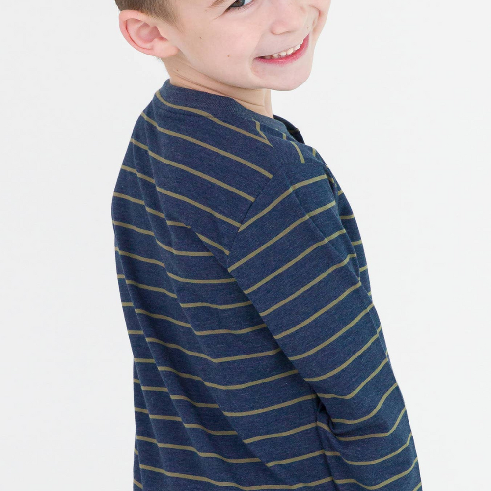 
                      
                        Stylish little boy showcasing the Boys Dusty Olive Stripe Knit Long Sleeve Henley Tee in a playful pose in a studio.
                      
                    