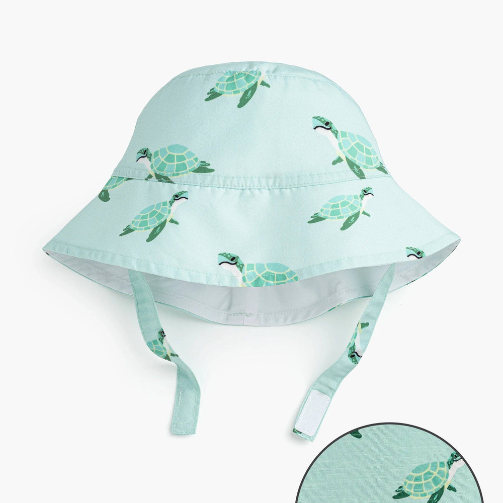 Flat lay of Sea Turtles sun hat with close-up of cheerful sea turtle print on recycled polyester