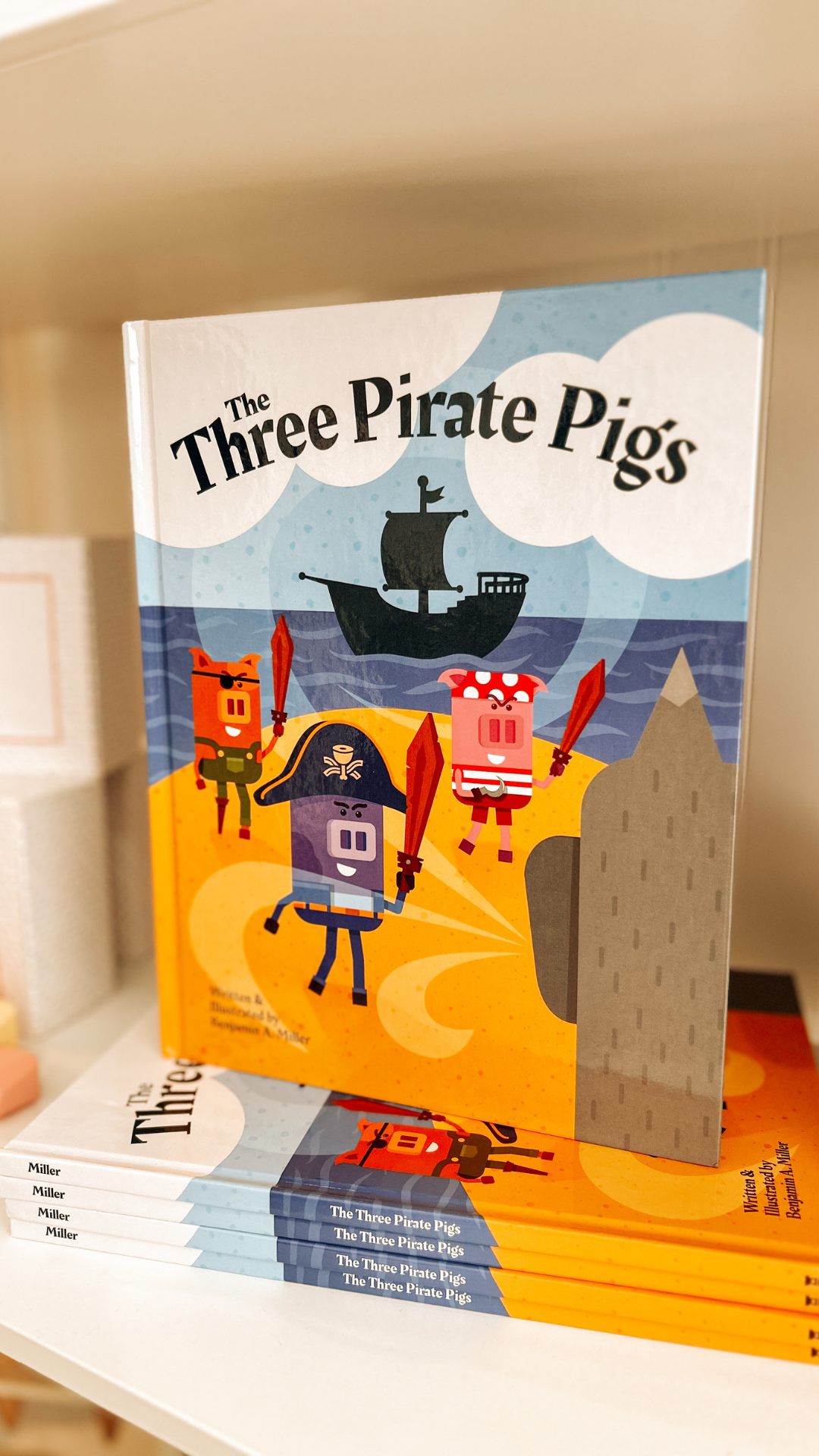 “The Three Pirate Pigs” children’s book displayed on a shelf at Grace & Haven in Essex, CT, featuring its whimsical cover illustration of the three pirate pigs.