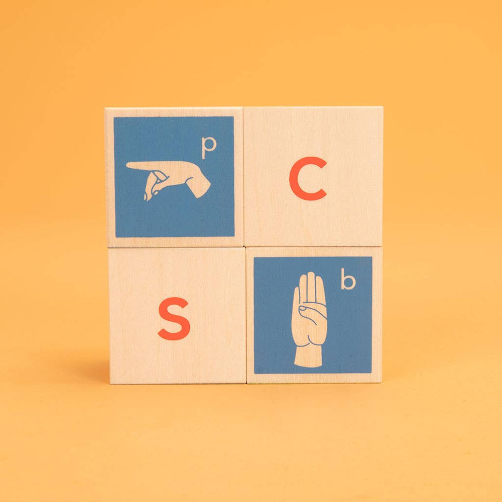 
                      
                        Four Uncle Goose ASL wooden blocks displayed together to reveal a mix of sign language symbols and letters across the sides
                      
                    