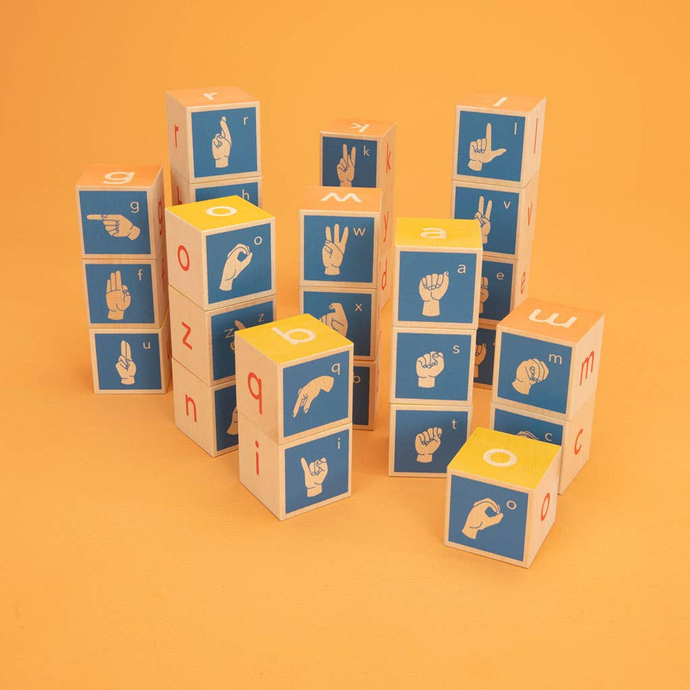Stack of Uncle Goose American Sign Language wooden blocks on an orange background, showcasing vibrant colors and debossed ASL symbols