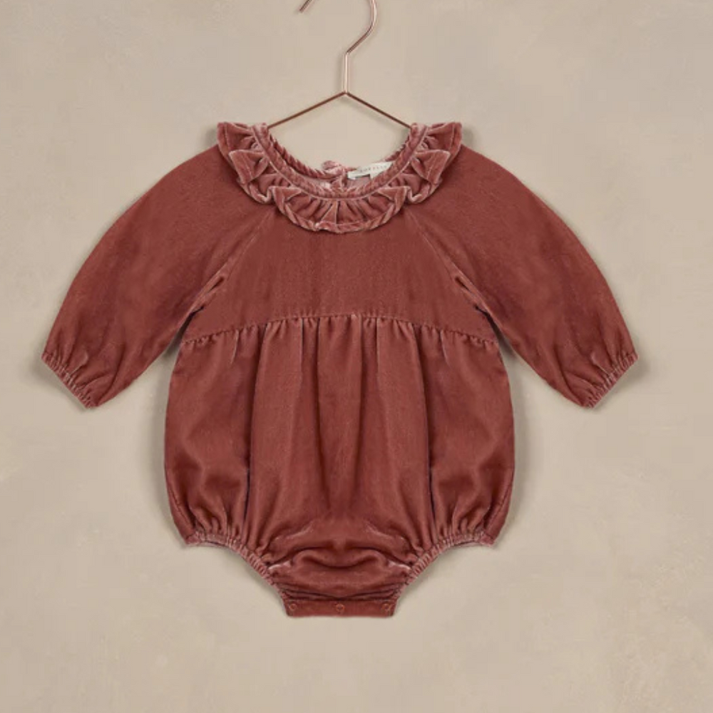 Flat lay of the Adeline Velvet Romper in Poppy, crafted from 100% cotton for comfort and elegance.