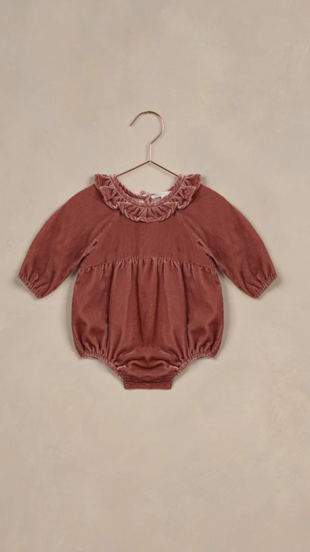 Flat lay of the Adeline Velvet Romper in Poppy, crafted from 100% cotton for comfort and elegance.