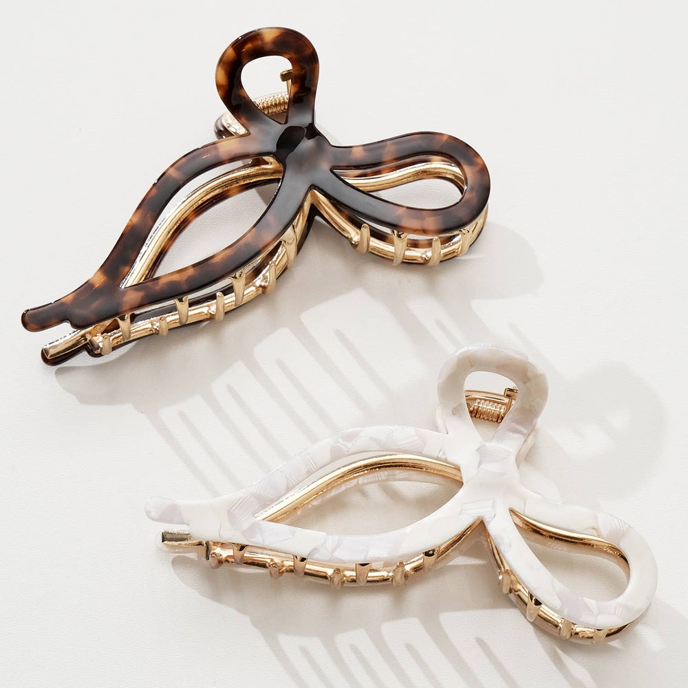 Flatlay of Vintage Snow Large Bow Claw Clip in Snow Fall and Tortoise finish