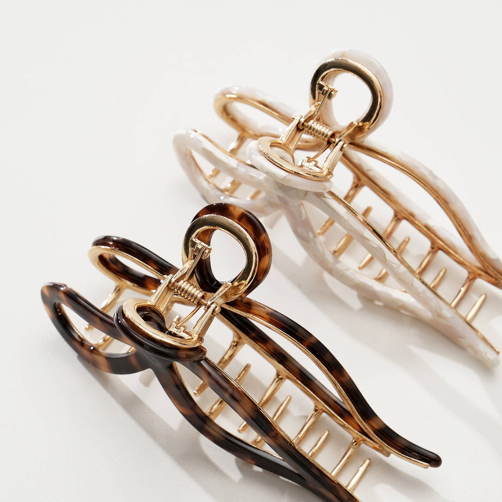 
                      
                        Top view of Sabrina Vintage Snow Large Bow Claw Clip highlighting gold base
                      
                    