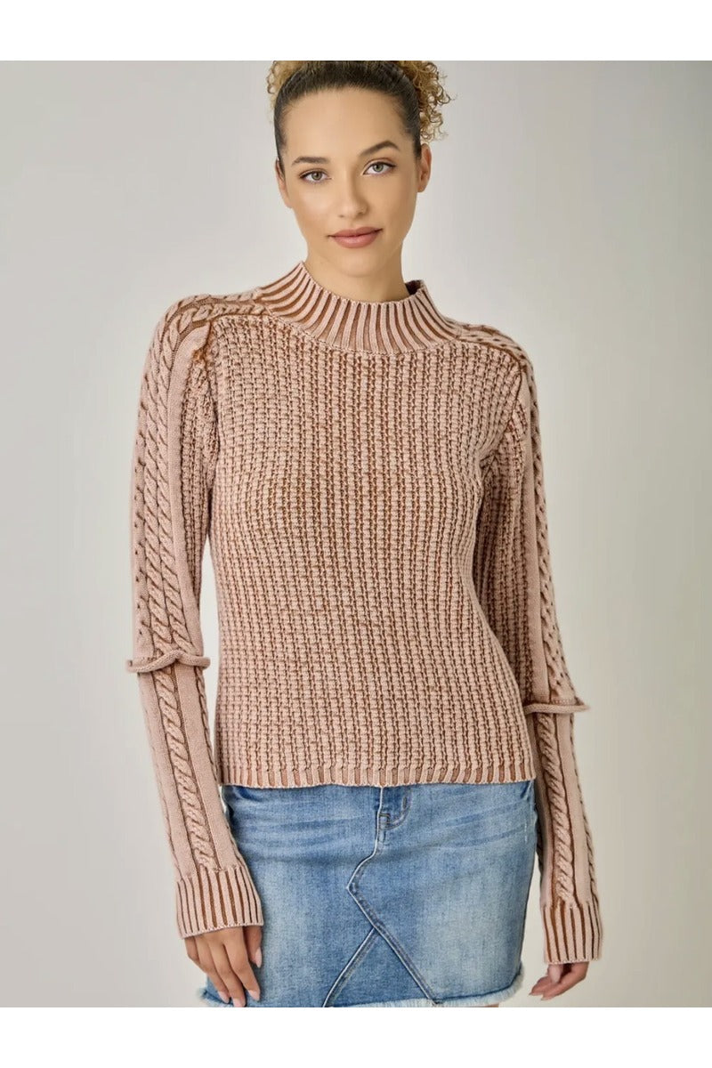 Front view of blush pink mock neck sweater with textured body and cable-knit sleeves