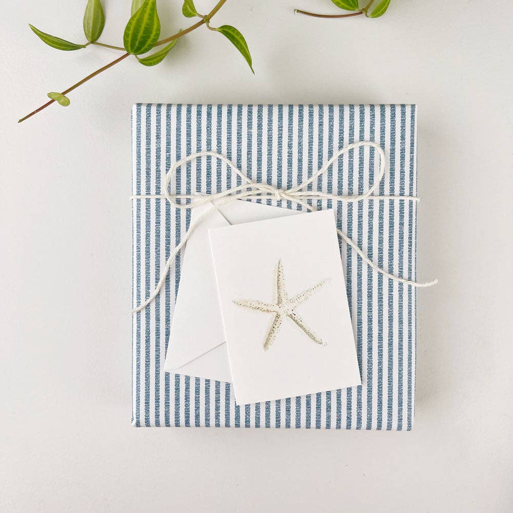 Close-up view of Emily Lex's Watercolor Starfish Tiny Notecard. The card features a beautifully painted starfish in soft watercolors, creating a calming, beach-inspired aesthetic. Perfect for sending thoughtful notes or as a small, heartfelt addition to any gift. The card's delicate design and simplicity make it ideal for a variety of occasions.